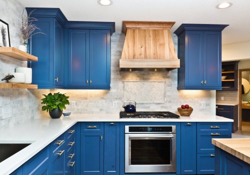 A contemporary kitchen renovation remodeling featuring a center island, hardwood floor and quartz counter.